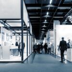 How Trade Shows Can Remain Relevant trade show floor with men and women in business attire