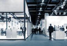 How Trade Shows Can Remain Relevant trade show floor with men and women in business attire