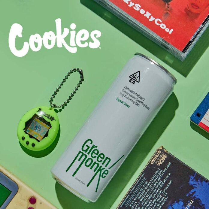 green monke beverage can on a green background with the cookies label in the upper right corner and a tomagatchi next to the can