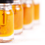 Extracting the Bottom Line Macro detail of dropper with CBD oil, cannabis live resin extraction isolated on white - medical marijuana concept