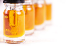 Extracting the Bottom Line Macro detail of dropper with CBD oil, cannabis live resin extraction isolated on white - medical marijuana concept