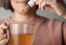 FDA Regulation Could Add $4.5 Billion to the CBD Market by 2027 Cbd hemp oil - Woman taking cannabis oil in tea cup - Focus on drop