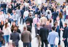 5 Essential Tips for Your Big Return to In-Person Conferences Crowd of anonymous business people at an industry conference expo event