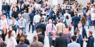 5 Essential Tips for Your Big Return to In-Person Conferences Crowd of anonymous business people at an industry conference expo event