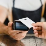 The $7B Cashless ATM Workaround Is Closing Fast Cashless payment method. Closeup shot of micro ATMs while customer paying with credit card in bar restaurant cafe. E-commerce e-banking concept.
