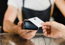 The $7B Cashless ATM Workaround Is Closing Fast Cashless payment method. Closeup shot of micro ATMs while customer paying with credit card in bar restaurant cafe. E-commerce e-banking concept.