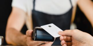 The $7B Cashless ATM Workaround Is Closing Fast Cashless payment method. Closeup shot of micro ATMs while customer paying with credit card in bar restaurant cafe. E-commerce e-banking concept.