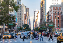 NYC’s Adult-Use Market Is Officially Open for Business Housing-Works-Cannabis-Co.-NEW YORK CITY - CIRCA 2017: Busy crowds of people walk across 3rd Avenue in front of rush hour traffic in the East Village neighborhood of Manhattan in New York City.
