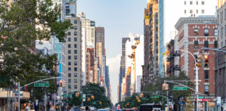 NYC’s Adult-Use Market Is Officially Open for Business Housing-Works-Cannabis-Co.-NEW YORK CITY - CIRCA 2017: Busy crowds of people walk across 3rd Avenue in front of rush hour traffic in the East Village neighborhood of Manhattan in New York City.
