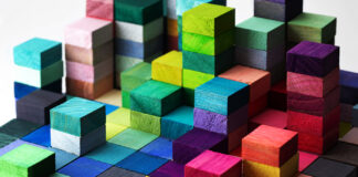 Champion Diversity by Learning How to Craft Inclusive Job Descriptions Spectrum of stacked multi-colored wooden blocks. Background or cover for something creative, diverse, expanding, rising or growing.