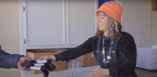 Join STIIIZY in Supporting Our Communities This Giving Season STIIIZY employee Sabrina helps distribute clothing items and necessities to other CANB clients