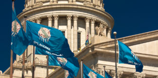 Medical Marijuana is Good Enough for Most Oklahoma Voters OCTOBER 11, 2018 Oklahma City USA -State Flag flies over Oklahoma State Capitol, Oklahoma City OK