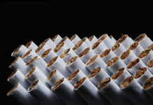 The Cannabis-Tobacco Worm Turns Cigarettes. Tobacco product. Heap of Tobacco Cigarettes on black background, close up from the front. Panoramic macro image, hi-res banner.