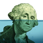 Is There a Solution to the Cash Crunch? Debt problems keeping your financial head above water represented by a drowning George Washington portrait sinking in blue water as a symbol of urgent business and money management failure and defeat.