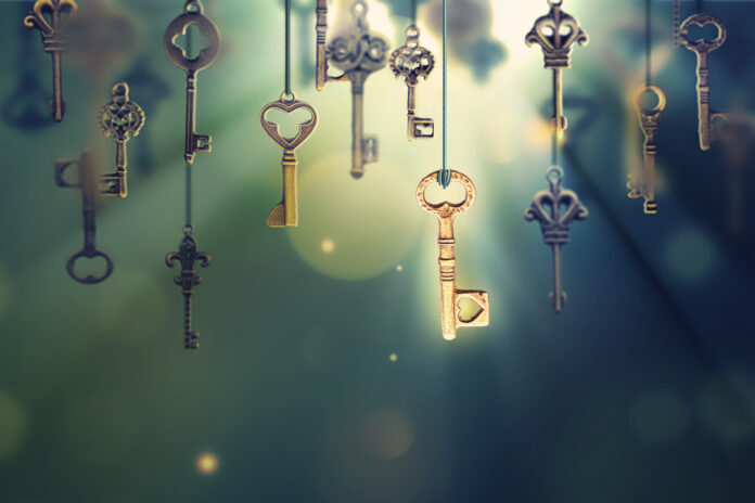 A conceptual image with hanging keys and one shining key. 3D illustration
