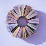 You Can’t Judge a Book by Its Cover … or Can You? Top,View,Of,Stack,Of,Books,In,Circle,On,Violet