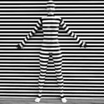 Cannabis Trademarks May Require a Tobacco Disguise 3D rendering of a woman trying to blend in with the black and white striped background, afraid to show her true colours. She is standing with her back against the wall and hiding like a wallflower.