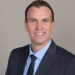 Brian Schnese male professional headshot in suit and tie
