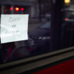 Trulieve Shutters California, Massachusetts Operations Hand written "Closed for Business" sign in the dark window of a shut down business