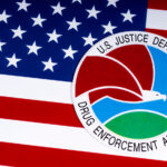 DEA Reports More Seizures, Fewer Arrests in 2022 The seal or symbol of the Drug Enforcement Administration DEA of the U.S. Justice Department, portrayed with the USA flag