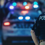 New York Takes a Bite Out of Illicit Cannabis Sales American policeman and police car in the background