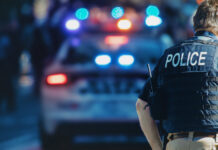 New York Takes a Bite Out of Illicit Cannabis Sales American policeman and police car in the background