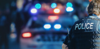 New York Takes a Bite Out of Illicit Cannabis Sales American policeman and police car in the background