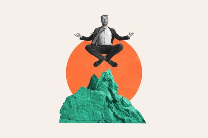 Zen businessman floating on mountain top