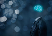 The Peril and Promise of AI Leader think about business, creativity, business vision and headhunter concept. Businessman without head just with brain, bokeh in background.