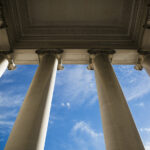 A DEA Judge Tried to Reschedule Cannabis 35 Years Ago Building column on a government building with a beautiful blue sky.