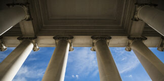 A DEA Judge Tried to Reschedule Cannabis 35 Years Ago Building column on a government building with a beautiful blue sky.