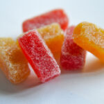 The Mainstream Appeal of Microdose THC Microdose Gummies in red and orange with a sugar coating