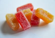 The Mainstream Appeal of Microdose THC Microdose Gummies in red and orange with a sugar coating