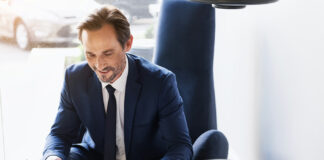 Defying Digital: The Resilience of Print Advertising in the Modern Age Businessman in suit reading magazine with morning coffee