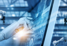 The Future is Automated Hand robot working on control panel in intelligent factory industrial monitoring system software. Check and control automation robot arms machine. Robotics and digital manufacturing operation system