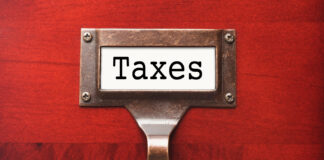 Cannabis Excise-Tax Revenue Fell Again in Q2 2023 Lustrous Wooden Cabinet with Taxes File Label