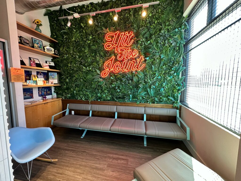 the joint denver dispensary interior plant wall and sign