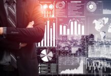 Cash Burn or Trust Earn: The Cannabis Investor’s Dilemma businessman in suit standing in front of a data analysis dashboards.