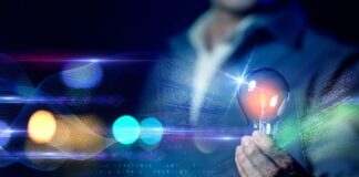 Know the Difference Between PR and Marketing Business man holding light bulb with night colorful light background, technology idea creativity futuristic future business investment innovation.