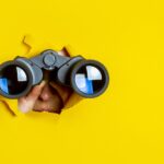 What to Watch in 2024 looking into the future of cannabis female holding binoculars