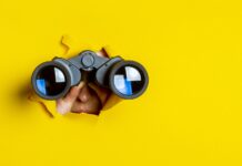 What to Watch in 2024 looking into the future of cannabis female holding binoculars