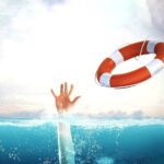 6 Strategies to Consider Before Slashing Prices Throwing a life rope buoy to a drowning person holding a hand above water.