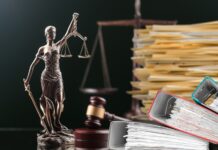 Slow but Significant Progress: Update on 3 Catalyst Cannabis Lawsuits Scales of justice, hammer, gavel, and legal files on a judges desk for glass house brands catalyst lawsuits