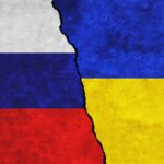 Russia,And,Ukraine,Painted,Flags,On,A,Wall,With,A