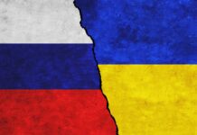 Russia,And,Ukraine,Painted,Flags,On,A,Wall,With,A