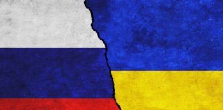 Russia,And,Ukraine,Painted,Flags,On,A,Wall,With,A