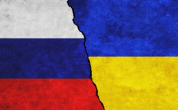 Russia,And,Ukraine,Painted,Flags,On,A,Wall,With,A