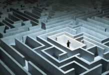 How to Prepare for Your Cannabis License Application Process Businessman stuck in maze looking lost wearing a suit.