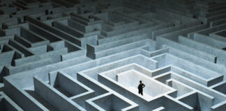 How to Prepare for Your Cannabis License Application Process Businessman stuck in maze looking lost wearing a suit.