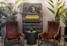 Staying on Top of Trends Lowell joint and pre-roll vending machine inside a dispensary waiting room with two mid century modern chairs and plants